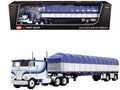 Peterbilt 352 COE 110" Sleeper and 53' Wilson Roadbrute Flatbed Trailer with Covered Wagon White with Blue Stripes 1/64 Diecast Model by DCP/First Gear